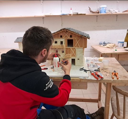 A man is building a nativity scene