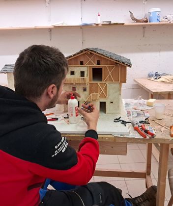A man is building a nativity scene